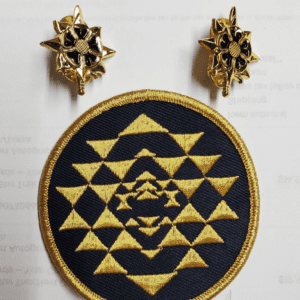 Gold embroidered patch with geometric pattern.